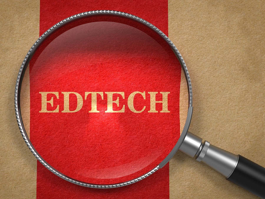 Magnifying glass placed over the word ‘EDTECH’.