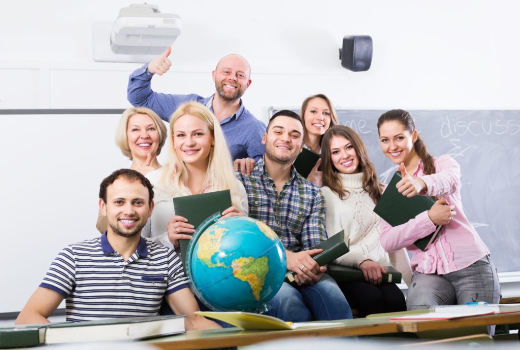 Portrait of happy teachers smiling in a classroom.