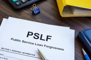 A close-up of a piece of paper that says “public service loan forgiveness.”