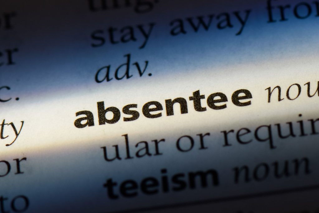 ‘Absentee’ with its definition on a dictionary page.